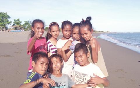 Children pose for the camera. 