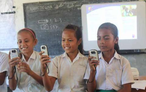 Three girls hold cameras. 